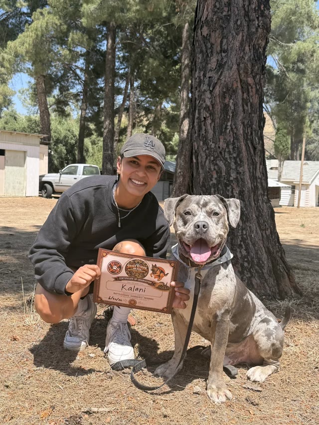 Giovanna Vera with her dog Kalani and their Snake School graduation diploma