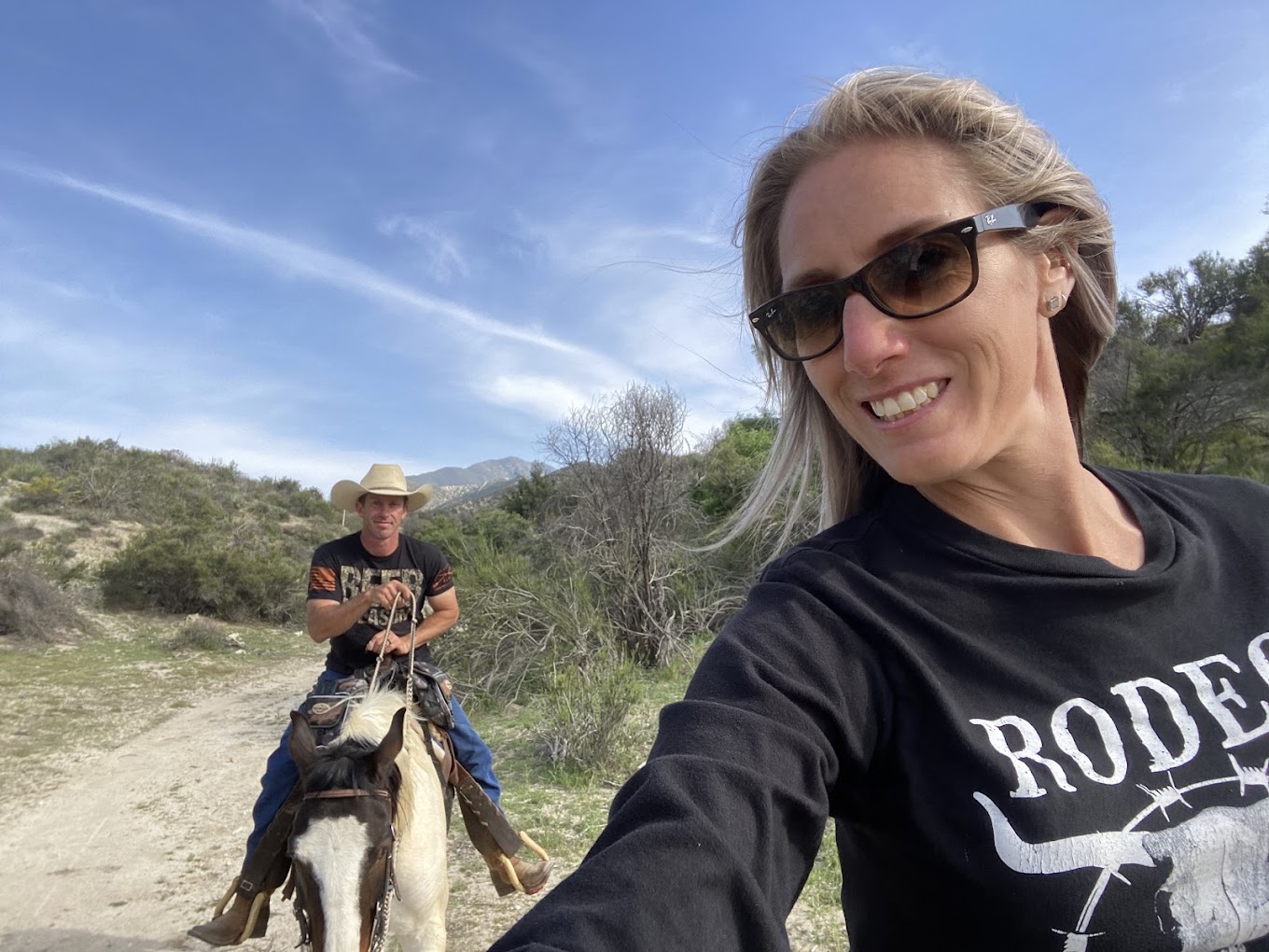 Shane Armstrong and his wife on horseback at the ranch